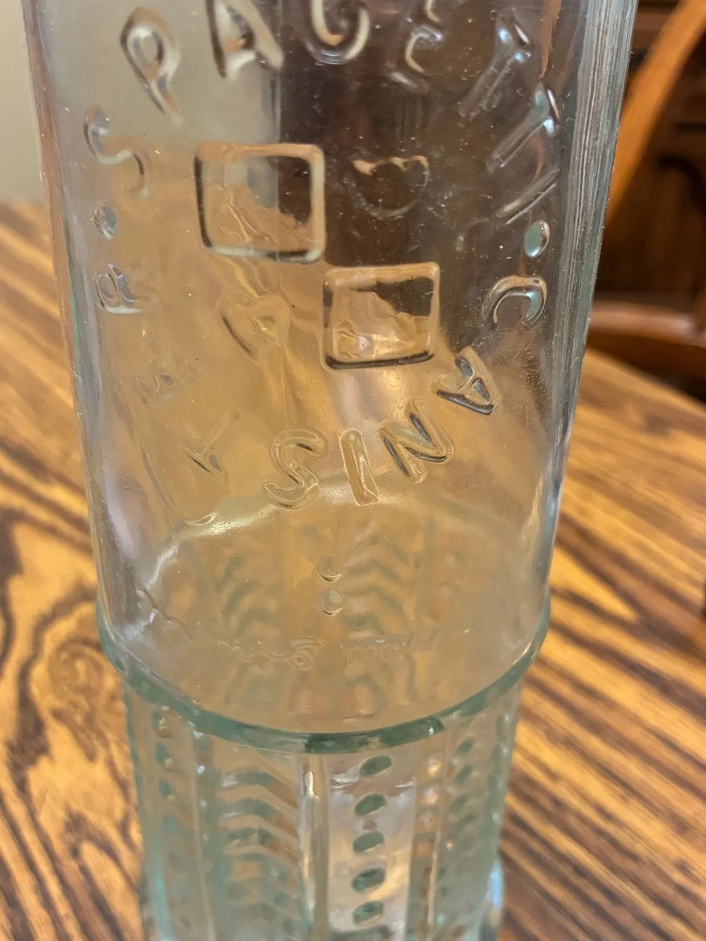 vintage glass spaghetti canister features an embossed circular logo
